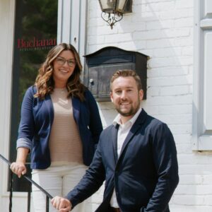 Meg Yocum, John Reynolds on steps of Buchanan Public Relations